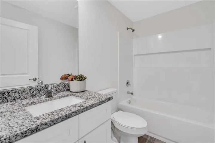 Full bathroom featuring vanity, toilet, and bathing tub / shower combination
