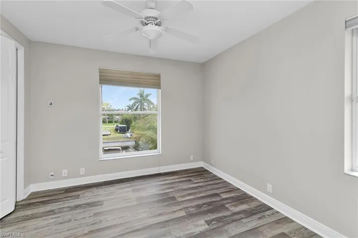 Empty room with wood finished floors and ceiling fan