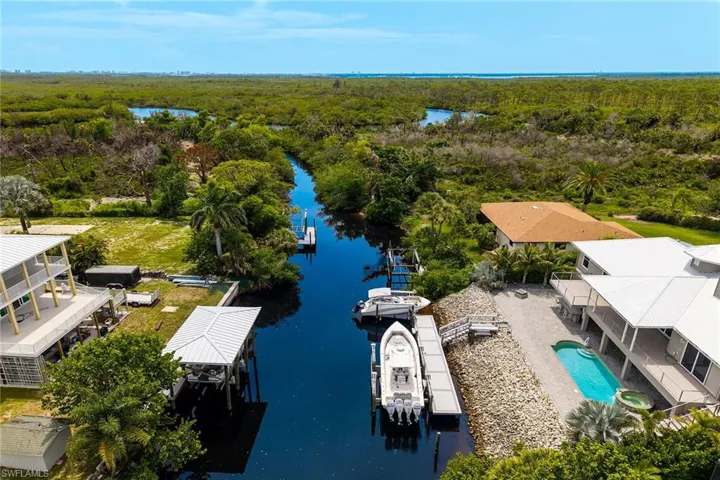 Drone / aerial view of a large body of water and a heavily wooded area