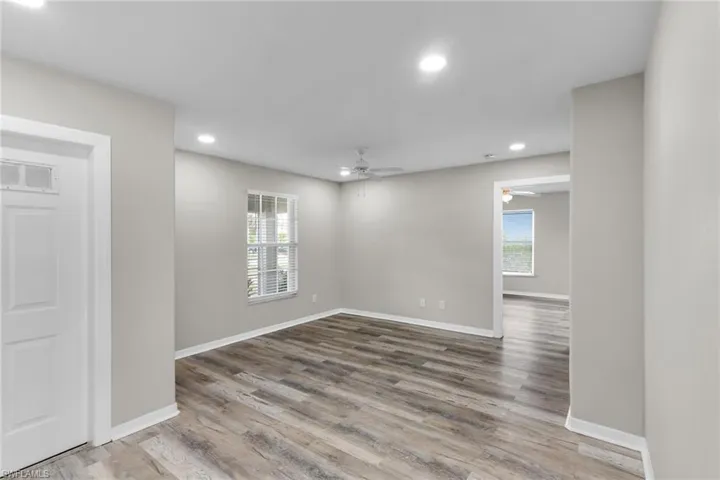 Spare room featuring a ceiling fan, plenty of natural light, wood finished floors, and recessed lighting