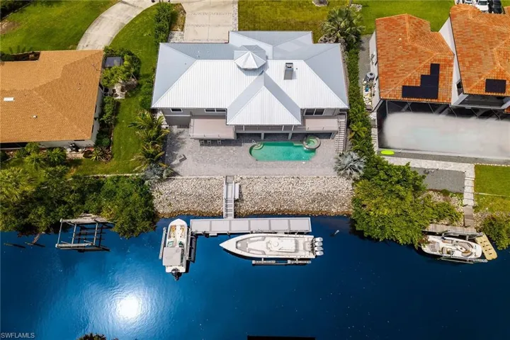 Drone / aerial view of a large body of water and a pool