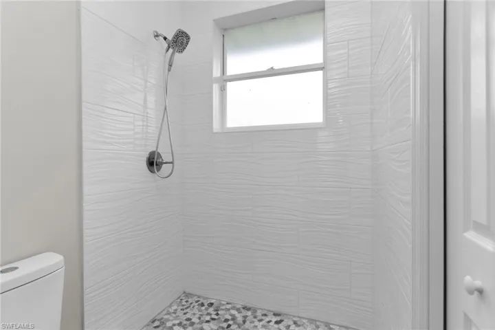 Bathroom with a tile shower and toilet
