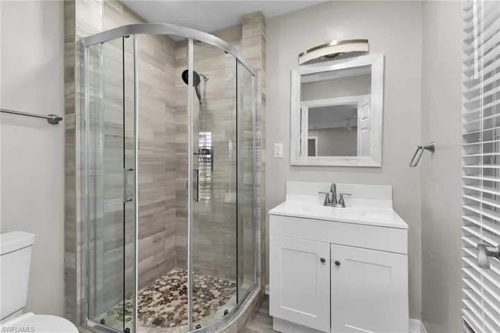 Full bathroom featuring vanity and a stall shower