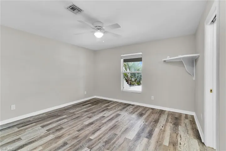 Unfurnished room with ceiling fan and wood finished floors
