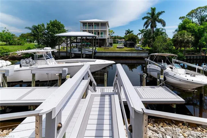 Dock area featuring a water view and boat lift