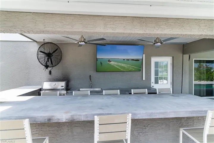 View of patio / terrace featuring ceiling fan and exterior kitchen