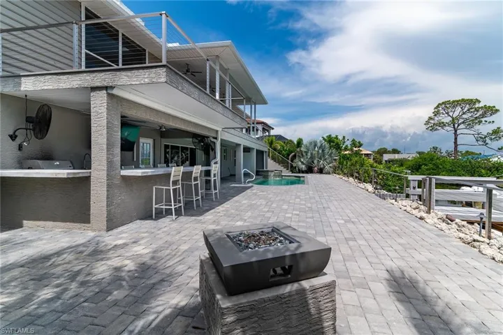 Patio / terrace featuring an outdoor fire pit, a patio, ceiling fan, and an outdoor pool