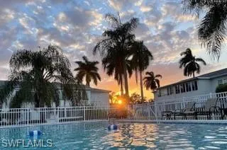 Pool at dusk with a community pool