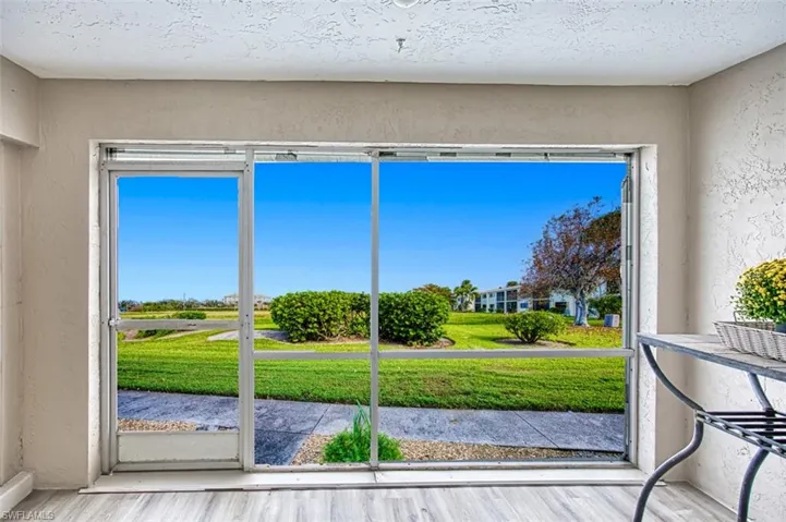 Screened Lanai Garden View. Walk out patio. New flooring.