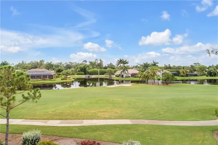Surrounding community featuring a water view and a lawn
