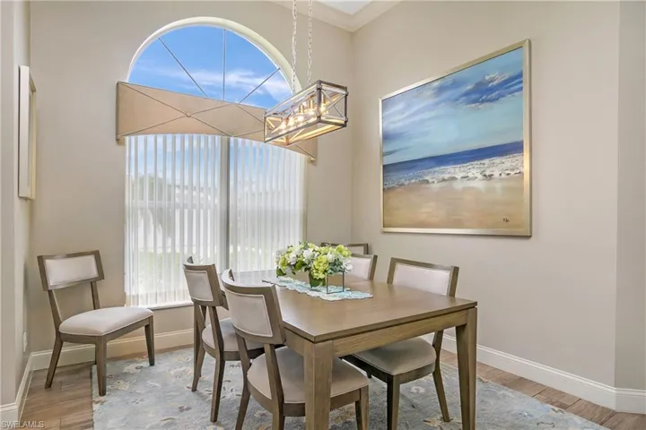 Dining space with hardwood / wood-style floors and a chandelier
