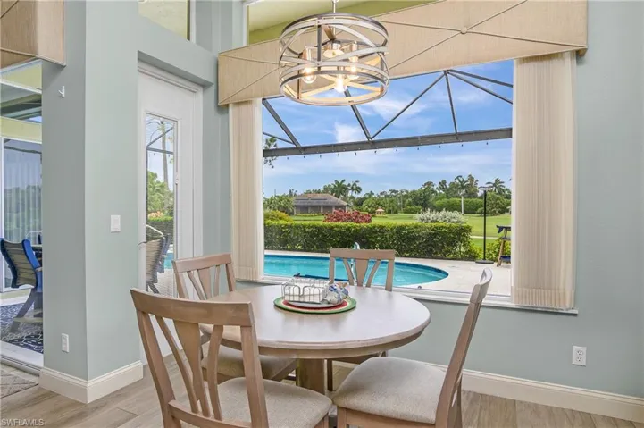 Dining area featuring hardwood / wood-style floors and an inviting chandelier
