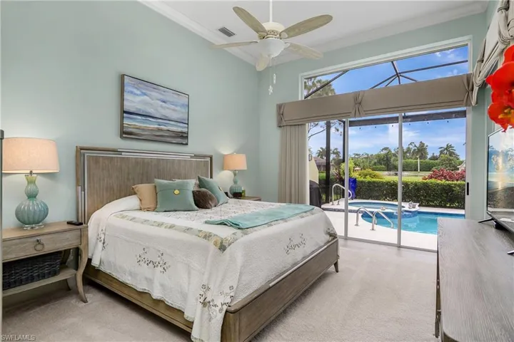 Carpeted bedroom featuring access to exterior, crown molding, and ceiling fan