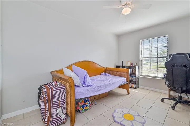 Tiled bedroom with ceiling fan