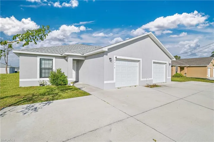 Single story home featuring a front yard and a garage