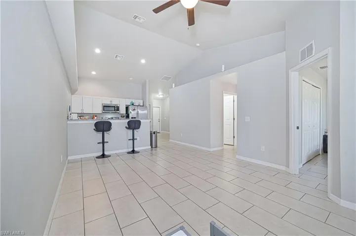 Living room with vaulted ceiling and ceiling fan