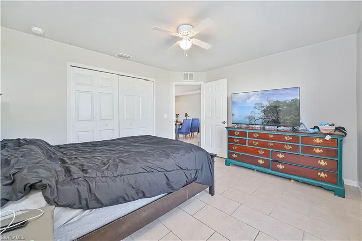 Tiled bedroom featuring a closet and ceiling fan