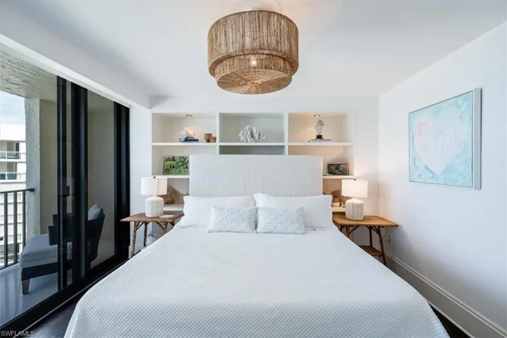Guest bedrrom 1 with built in shelves behind bed