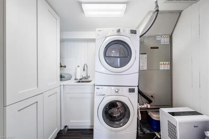 In unit laundry room and extra storage cabinets