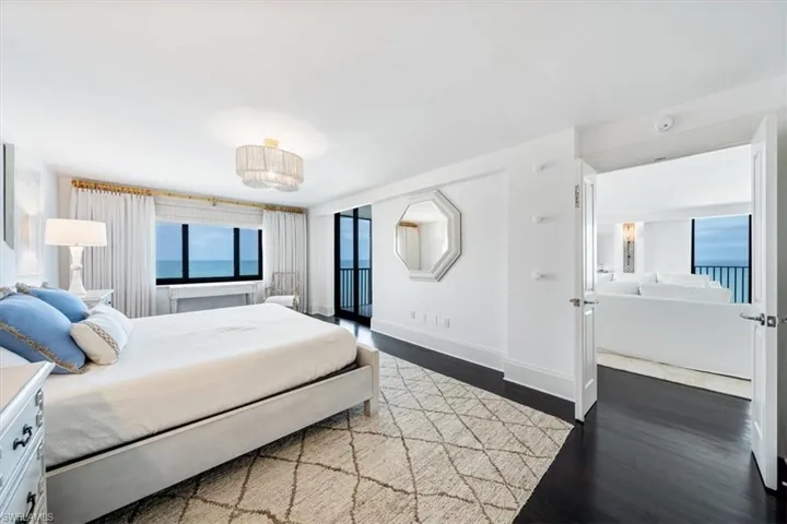 Primary bedroom with a window view of Gulf and sliding doors to the balcony