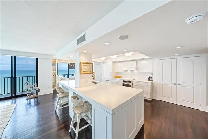 Open Kitchen with white cabinetry and built in appliances