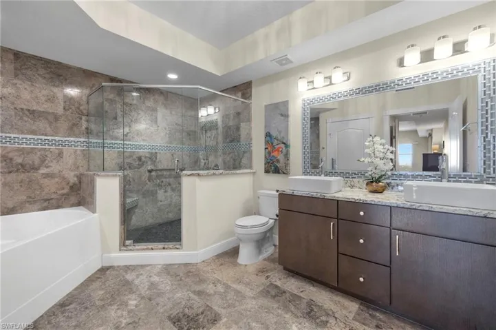 Oversized walk in shower with built in bench, garden tub & dual sinks