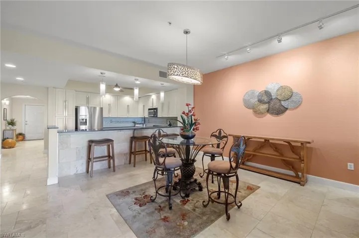 View of Kitchen and bar area/ recessed lighting throughout