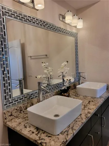 Double Sink Tile around mirror matching tile accents on walls in shower and tub