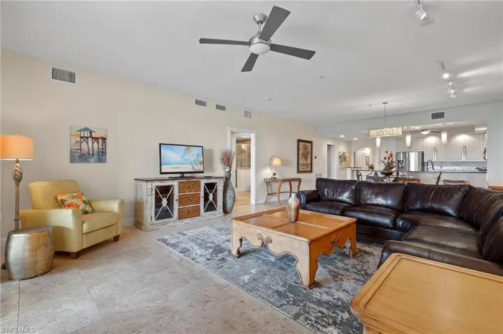 Spacious living area furnished with stylish, comfortable furnishings included with purchase (wall hangings not included)