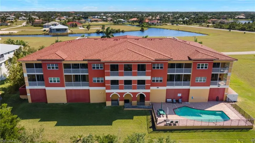 Back of Building with pool -  view of lake in front of building.