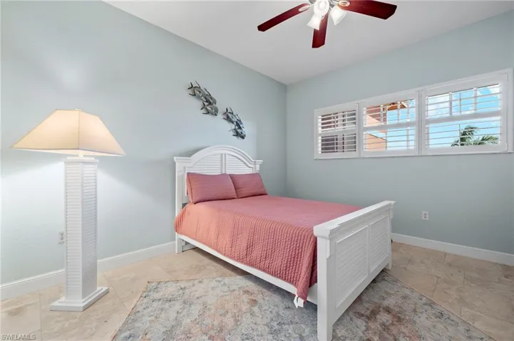 Bedroom # 2 to the right of entry hall across from Guest Bathroom.  Walk in custom closet, plantain shutters overlooking screened front of building