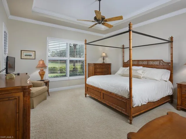 Primary bedroom suite with tray ceiling. Accommodates a king-sized bed with room to spare.