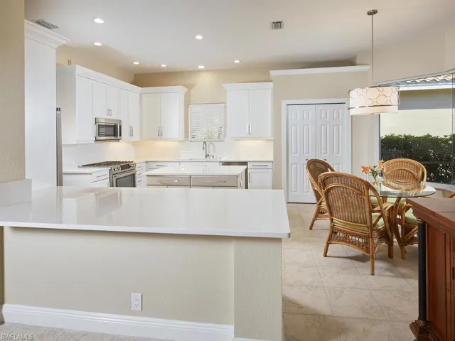 Kitchen just renovated...column and raised countertop in foreground removed and replaced with quartz. Perfect visibility between kitchen and great room! New 42" upper cabinets, quartz countertops and backsplash, new sink and plumbing, new LED ceiling light fixtures and breakfast nook light, newer stainless-steel appliances. Natural gas cooktop!
