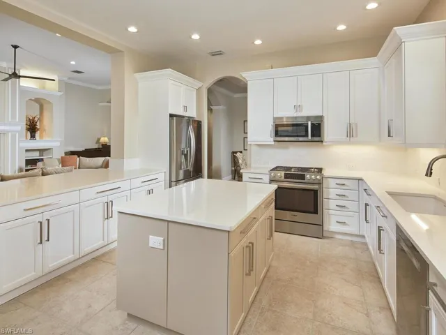 View standing in front of pantry looking toward great room and entry to dining room. Neutral tile floor.