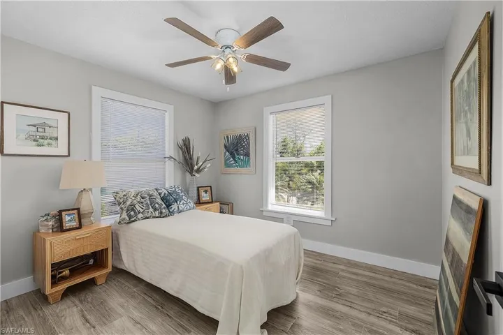 Bedroom featuring ceiling fan, baseboards, and wood finished floors