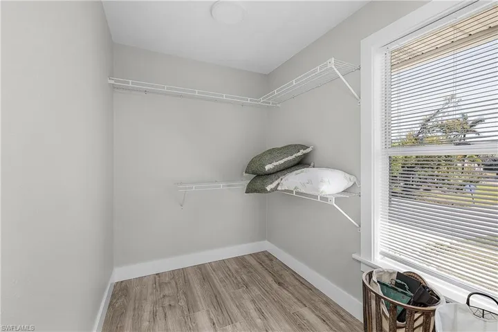 Walk in closet featuring wood finished floors