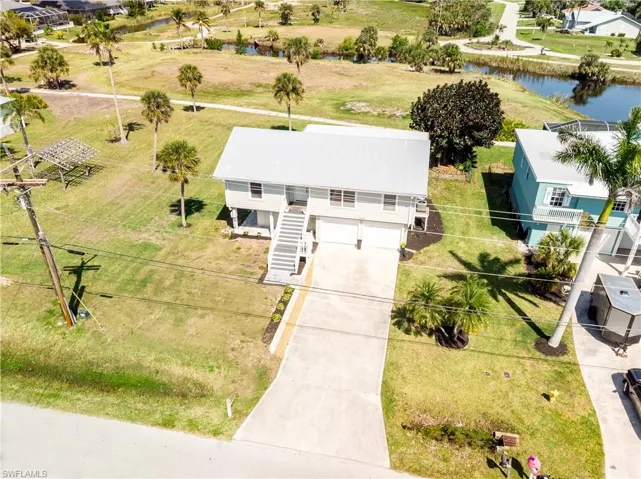 Birds eye view of property with a water view