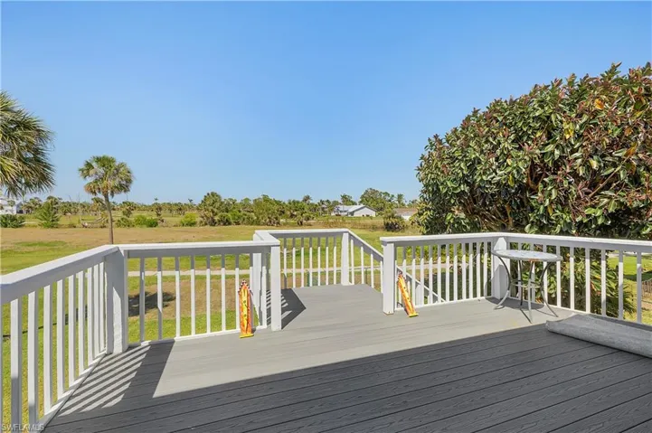 Wooden terrace featuring a yard