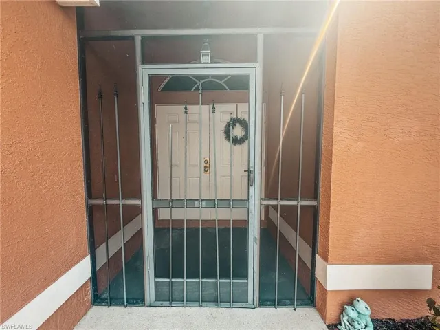 View of exterior entry with stucco siding