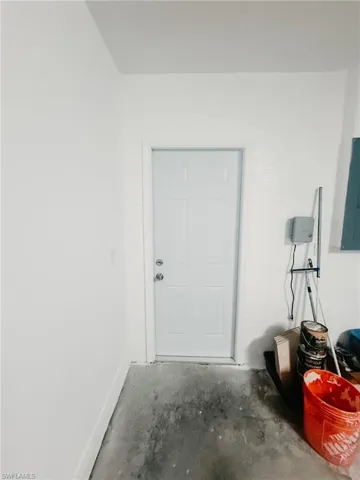 Entrance to property through garage featuring electric panel