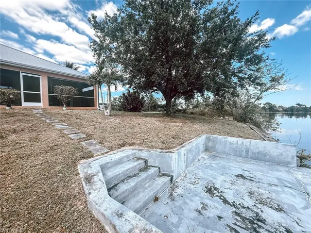 View of yard with a water view and patio