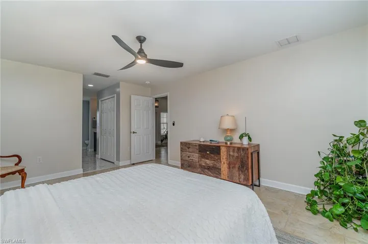 Bedroom with ceiling fan and a closet