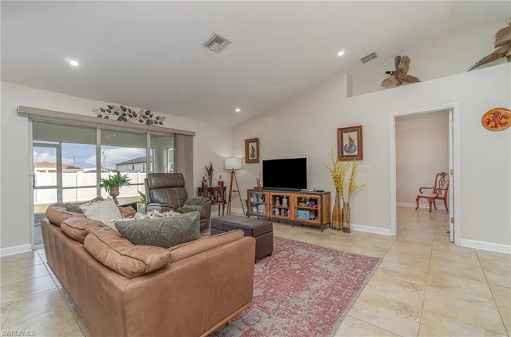 Living room featuring high vaulted ceiling