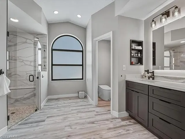 spa like retreat with dual solid wood cabinetry and smart faucets and toliet