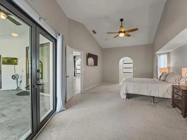primary bedroom with sitting area and garden impact doors to lanai