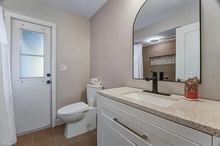 pool bath with all tile guest shower with bluetooth shower light