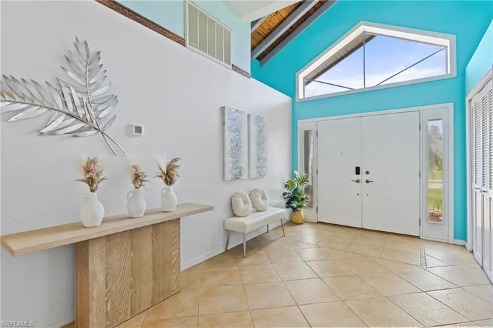 Tiled entrance foyer featuring high vaulted ceiling