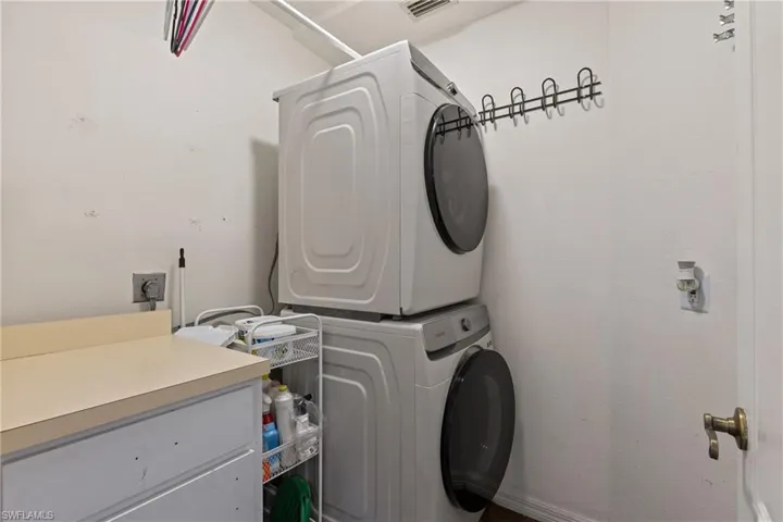 Washroom with stacked washer / drying machine