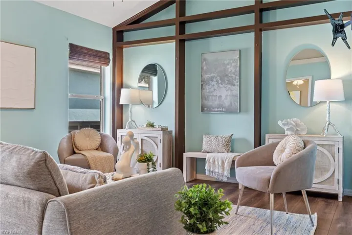 Sitting room featuring lofted ceiling and hardwood / wood-style flooring