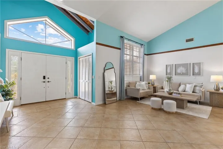 Entrance foyer featuring high vaulted ceiling and light tile patterned floors